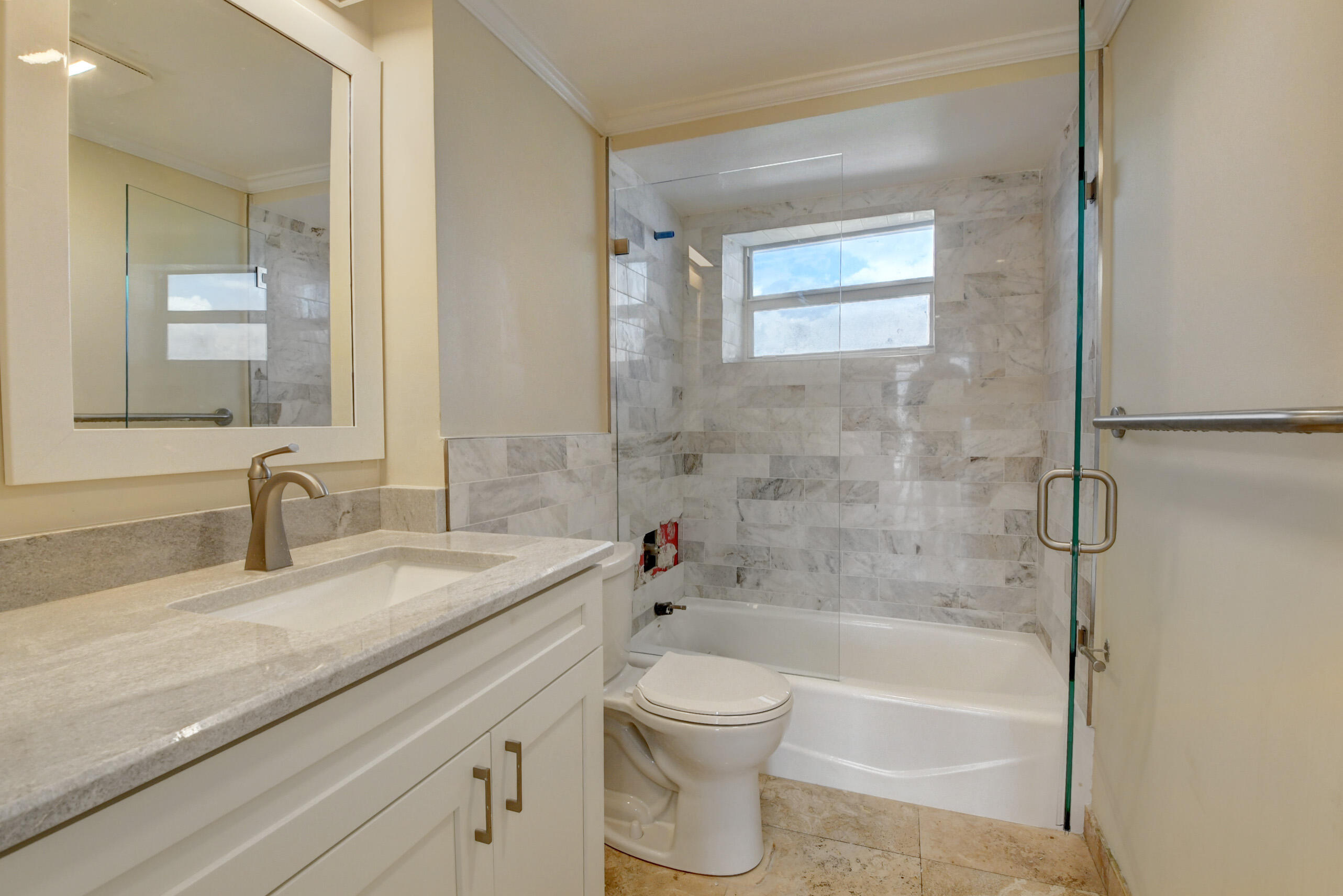 36 South Ocean Boulevard, Unit B3 Delray Beach, FL 33483 - Photo 2 of 47 a bathroom with a granite countertop sink a toilet and shower