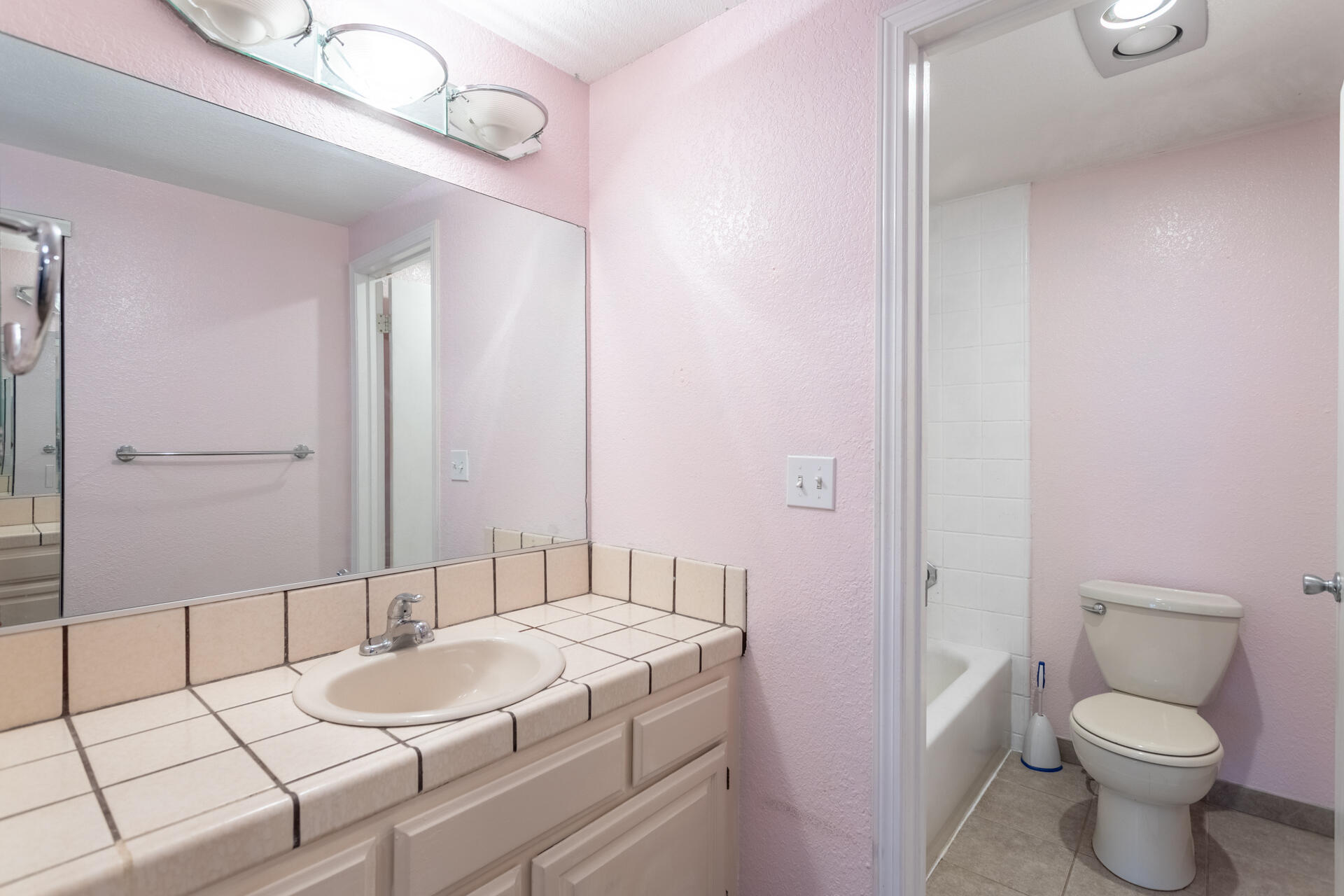 466 Ridgecrest Trail, Unit 136 Redding, CA 96003 - Photo 11 of 16 a bathroom with a granite countertop sink a toilet a mirror and shower