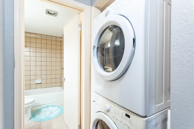 a view of a hallway with washer and dryer