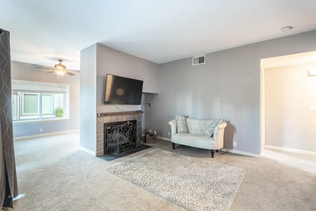 a living room with furniture and a fireplace