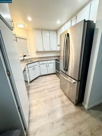 a kitchen with stainless steel appliances a refrigerator sink and microwave