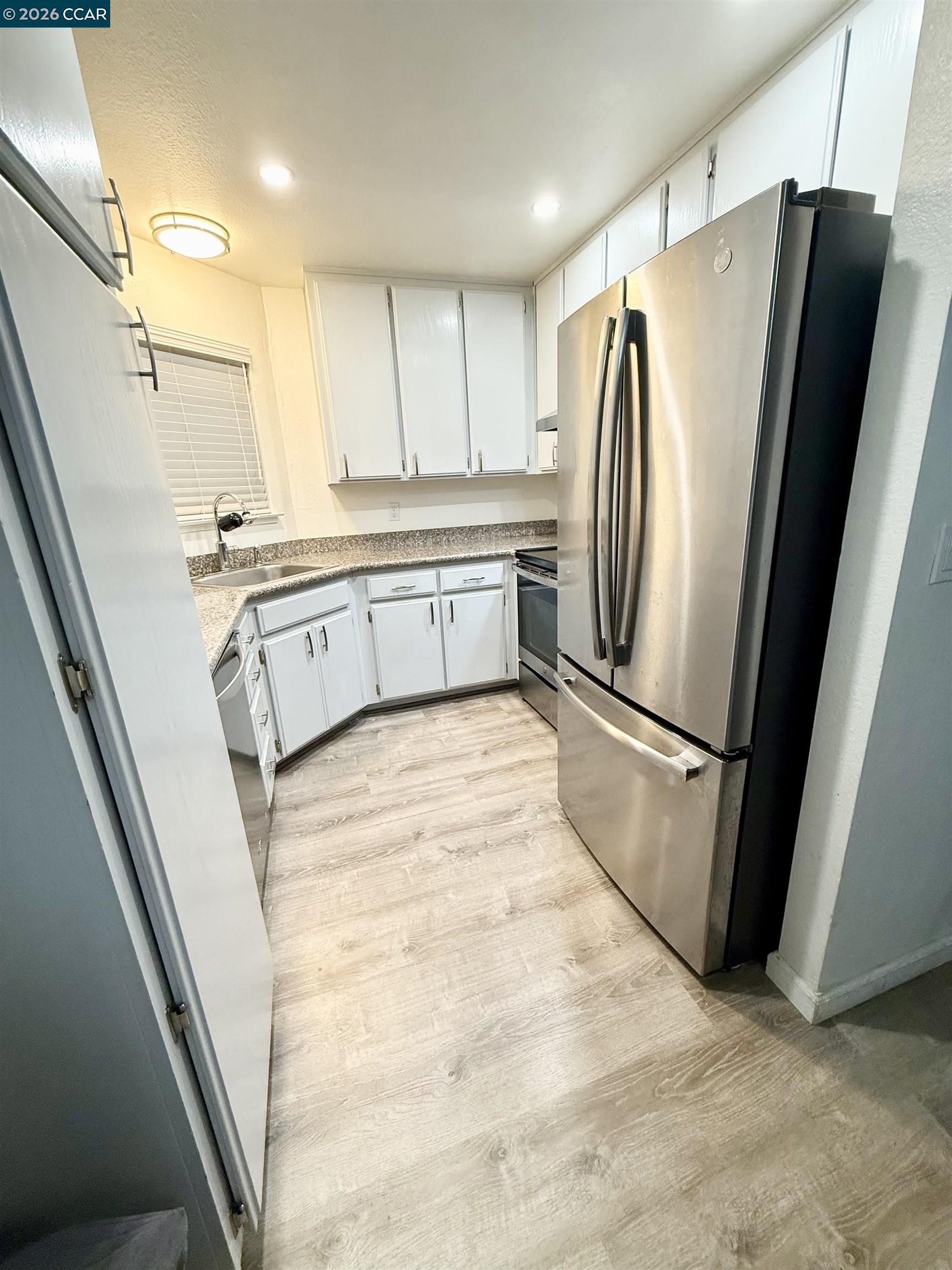 405 Weymouth Hercules, CA 94547 - Photo 6 of 22 a kitchen with stainless steel appliances a refrigerator sink and microwave