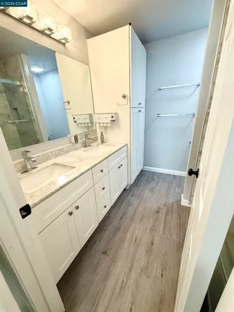 a bathroom with a double vanity sink and mirror