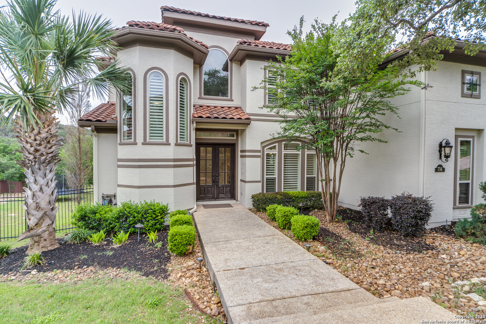 714 Ruidosa Downs Helotes, TX 78023 - Photo 1 of 42 a front view of a house with garden