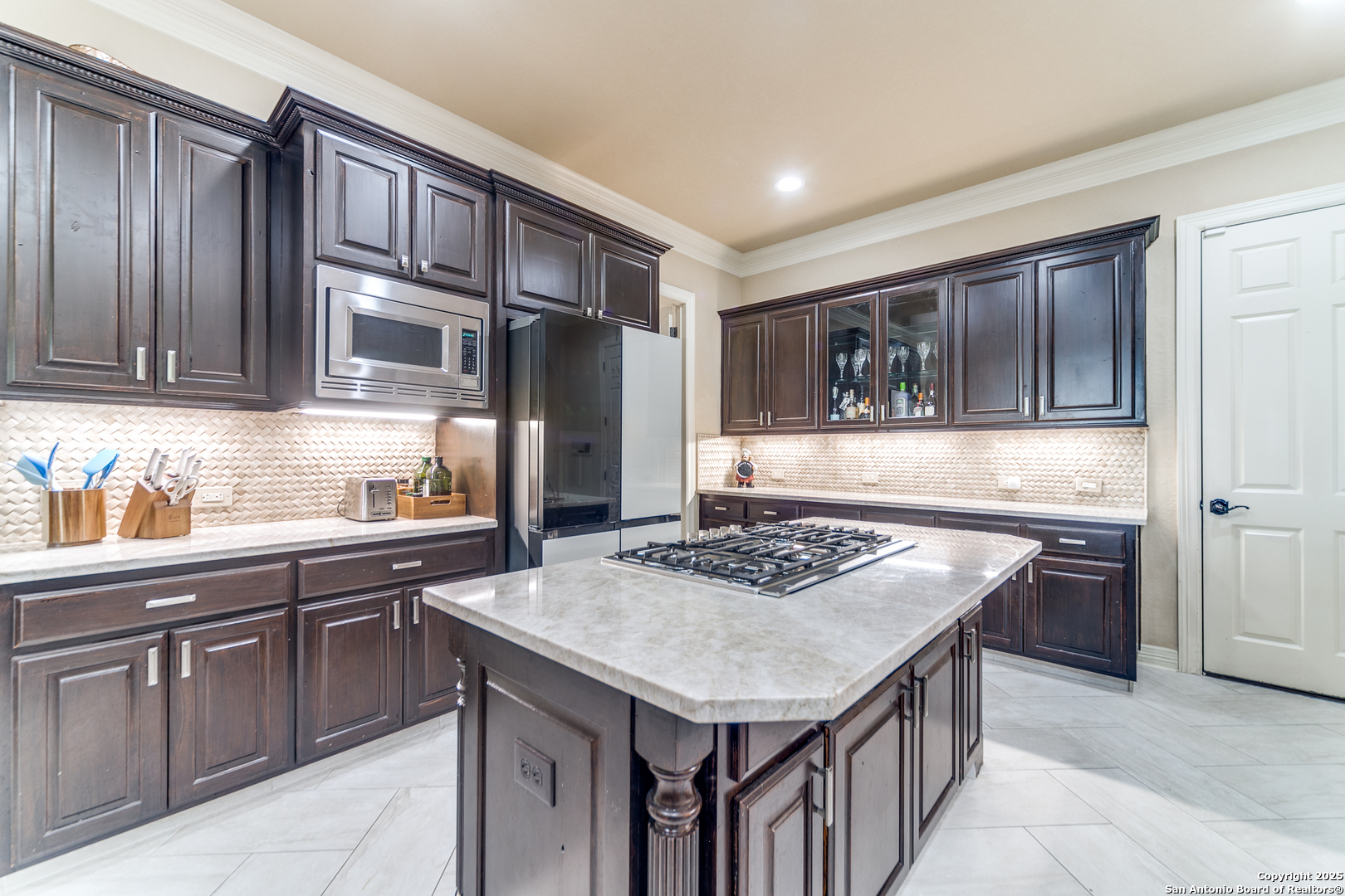 714 Ruidosa Downs Helotes, TX 78023 - Photo 12 of 42 a kitchen with a stove a sink and a refrigerator