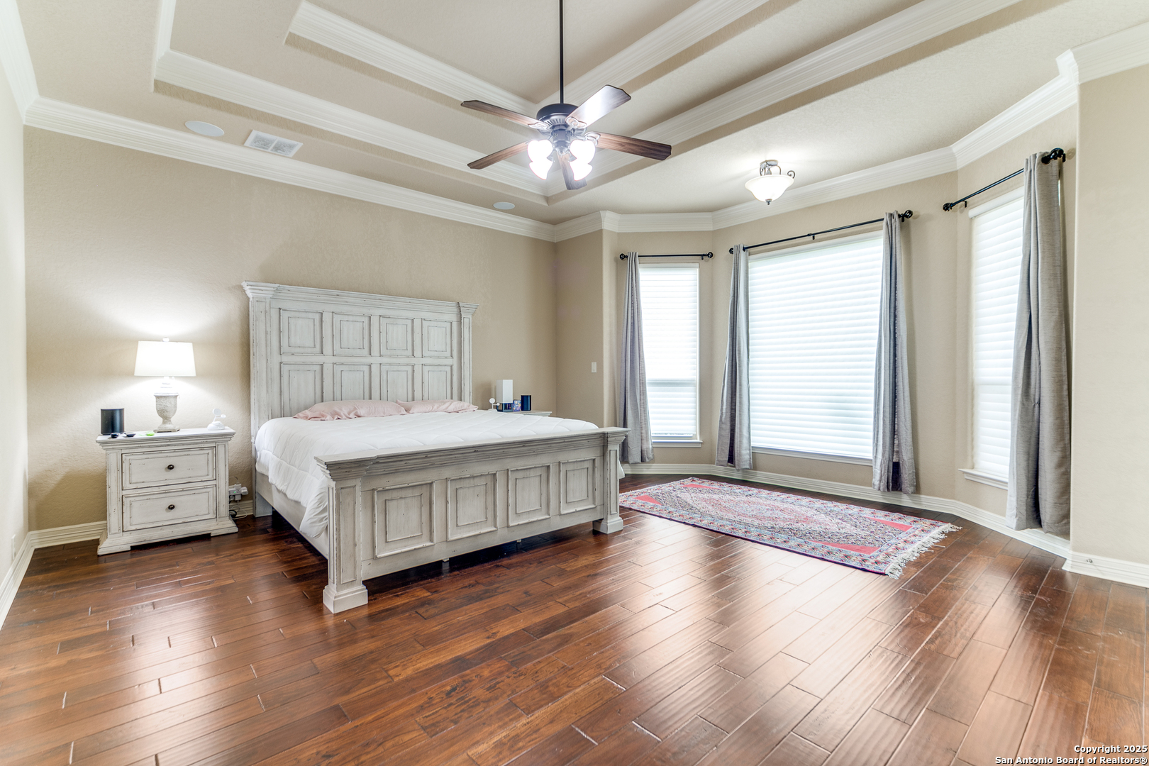 714 Ruidosa Downs Helotes, TX 78023 - Photo 13 of 42 a bedroom with a large bed and a chandelier