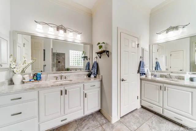 a bathroom with a double vanity sink mirror and