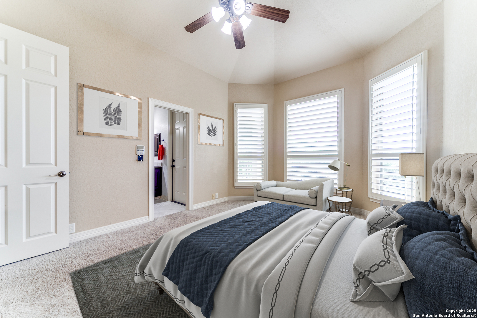 714 Ruidosa Downs Helotes, TX 78023 - Photo 17 of 42 a bedroom with a large bed and a chandelier