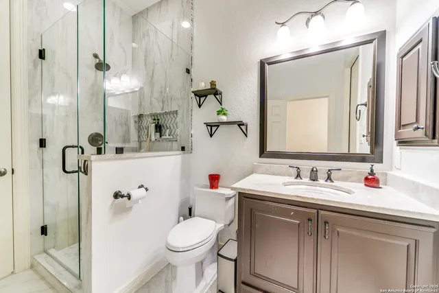 a bathroom with a sink toilet and shower