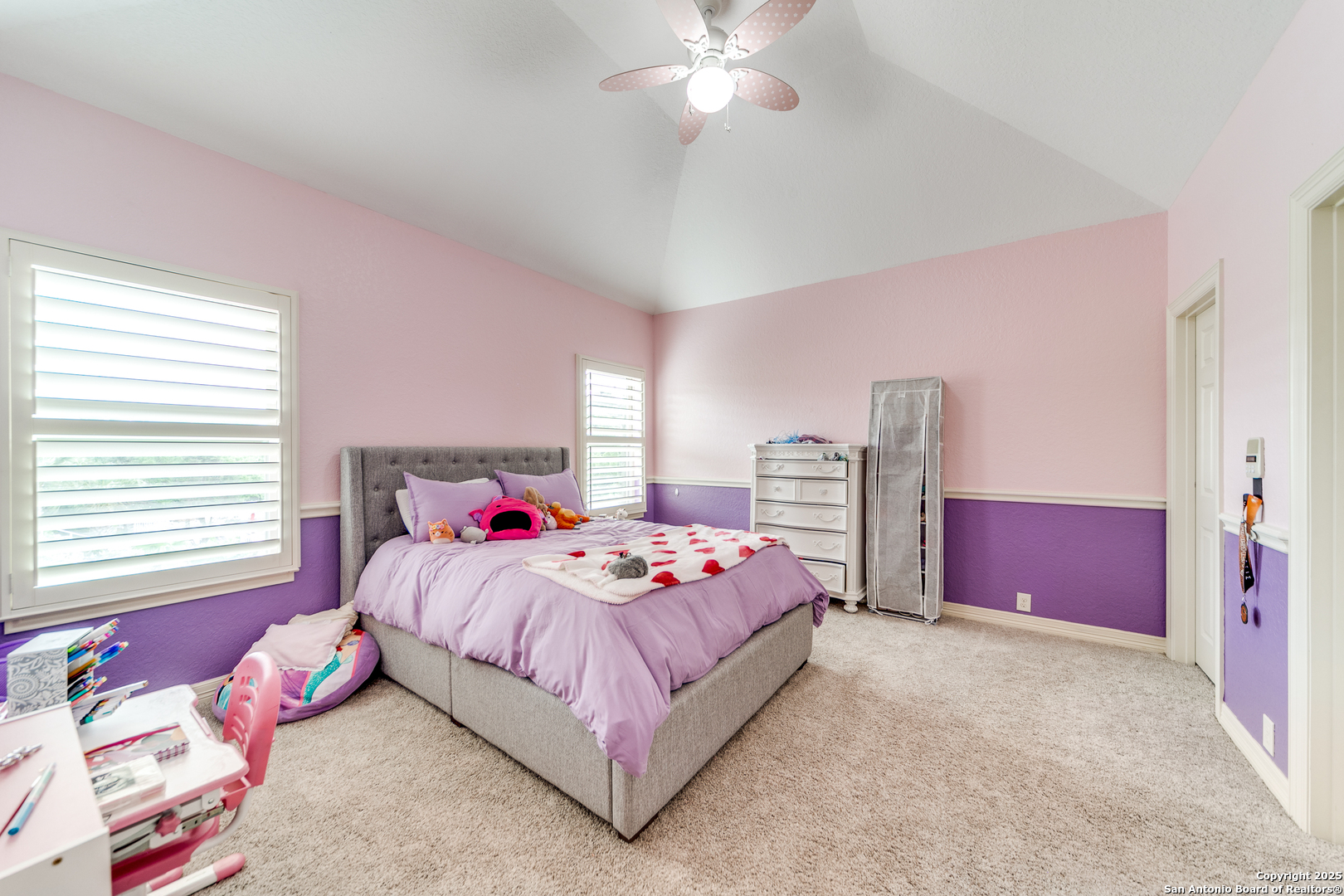 714 Ruidosa Downs Helotes, TX 78023 - Photo 19 of 42 a bedroom with a bed and a chandelier