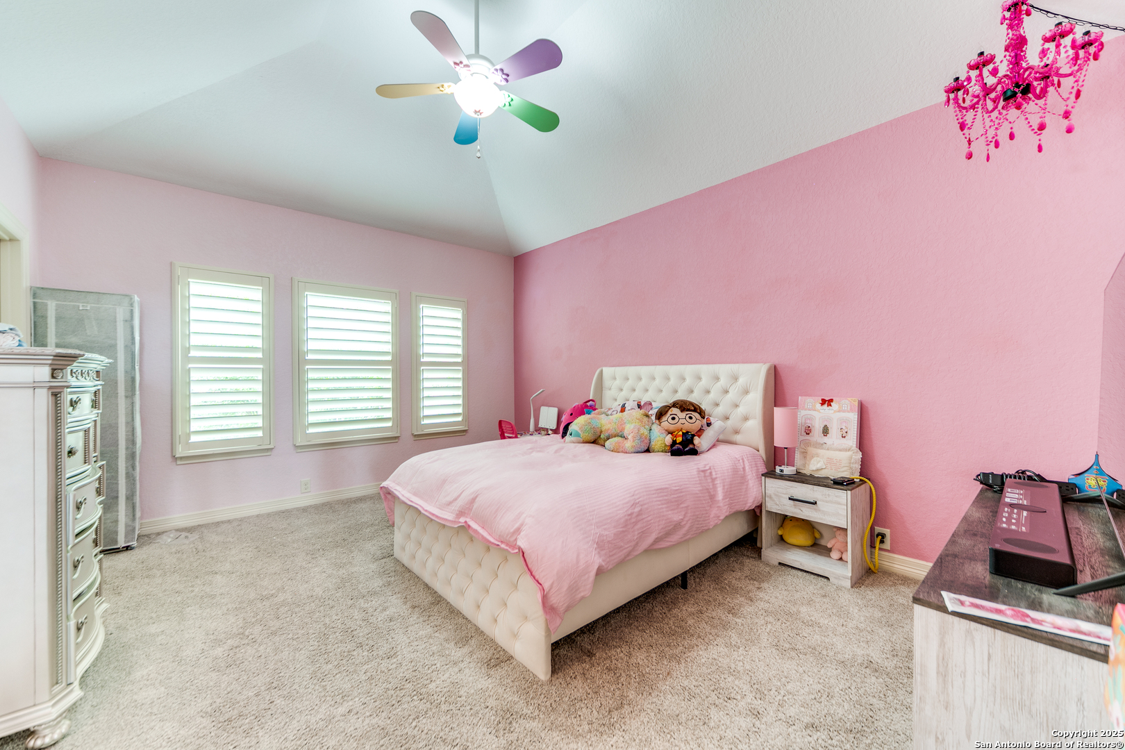 714 Ruidosa Downs Helotes, TX 78023 - Photo 20 of 42 a bedroom with a bed and a chandelier