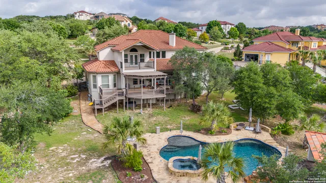 a aerial view of a house with yard and lake view