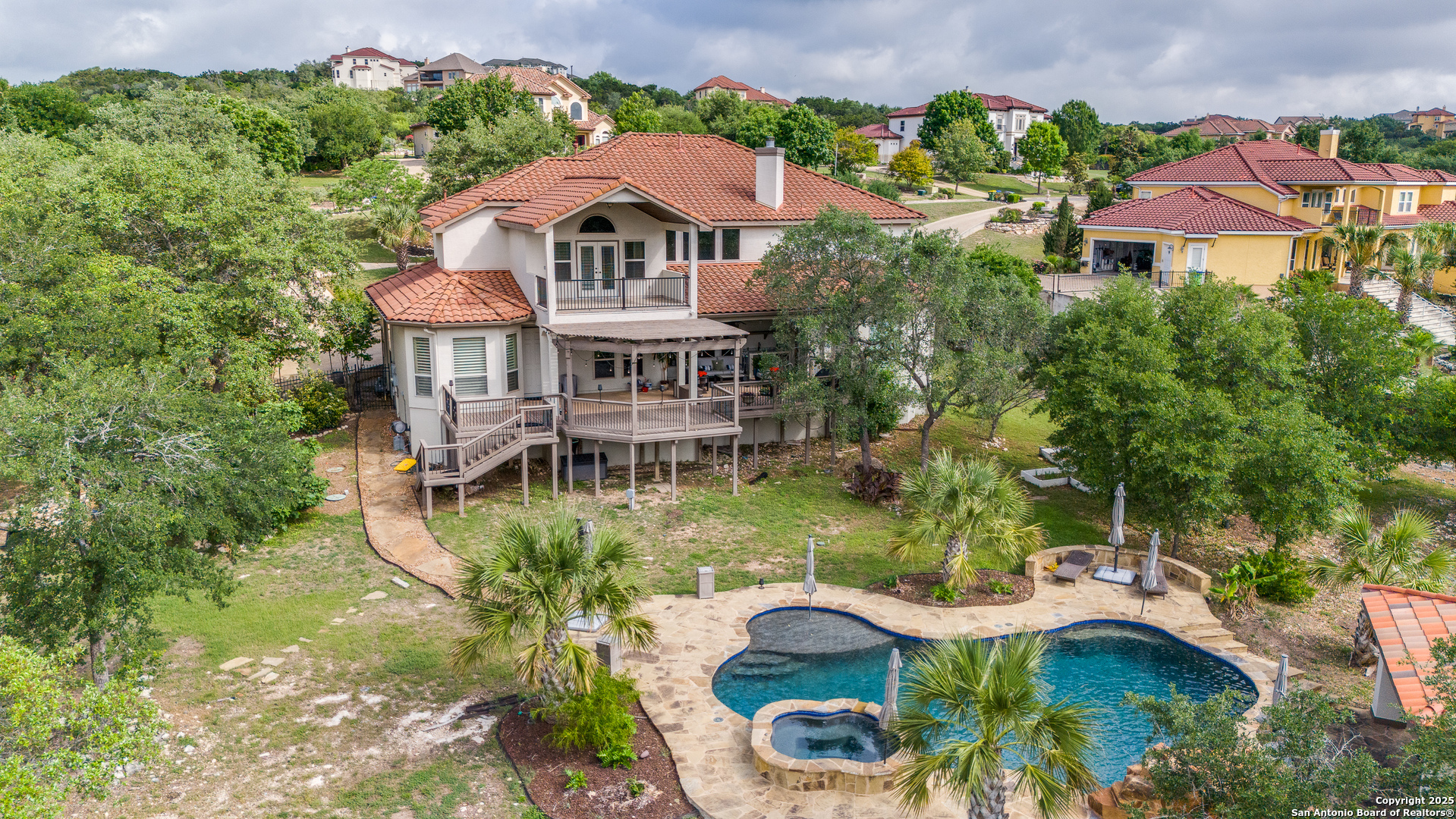 714 Ruidosa Downs Helotes, TX 78023 - Photo 2 of 42 a aerial view of a house with yard and lake view