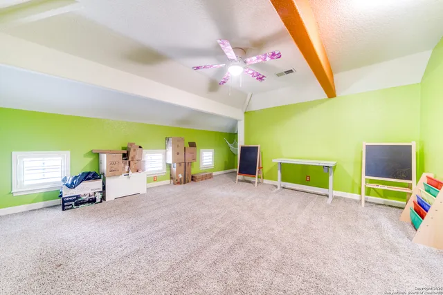a view of a room with gym equipment and a flat screen tv