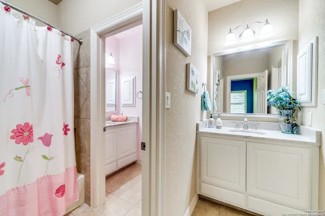 a bathroom with a sink vanity and a mirror
