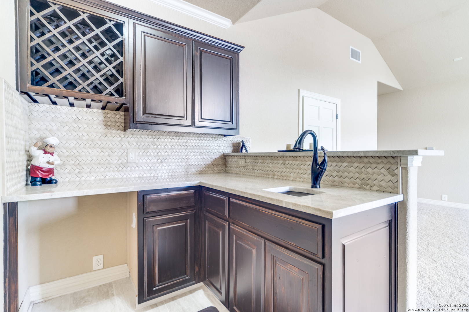 714 Ruidosa Downs Helotes, TX 78023 - Photo 27 of 42 a kitchen with a sink and cabinets