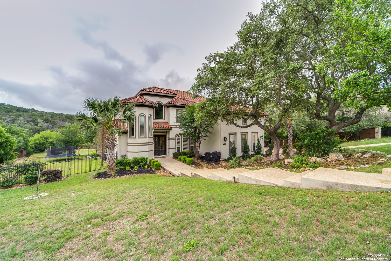 714 Ruidosa Downs Helotes, TX 78023 - Photo 3 of 42 a front view of a house with a yard and garage