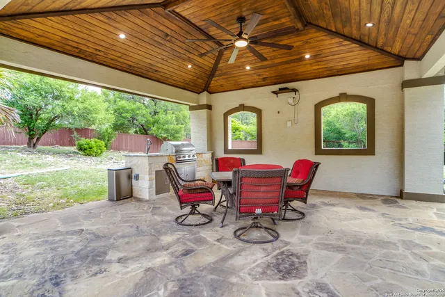 a view of a patio with table and chairs and potted plants