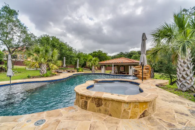 a view of swimming pool with seating space
