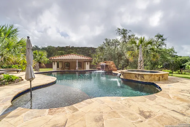 a view of a swimming pool with a yard