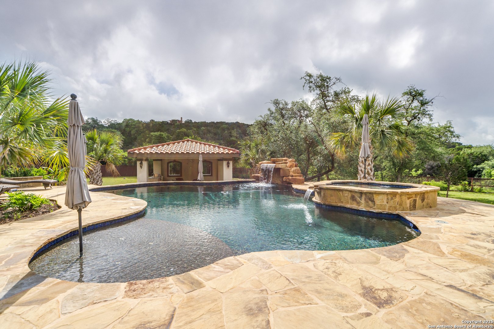 714 Ruidosa Downs Helotes, TX 78023 - Photo 38 of 42 a view of a swimming pool with a yard