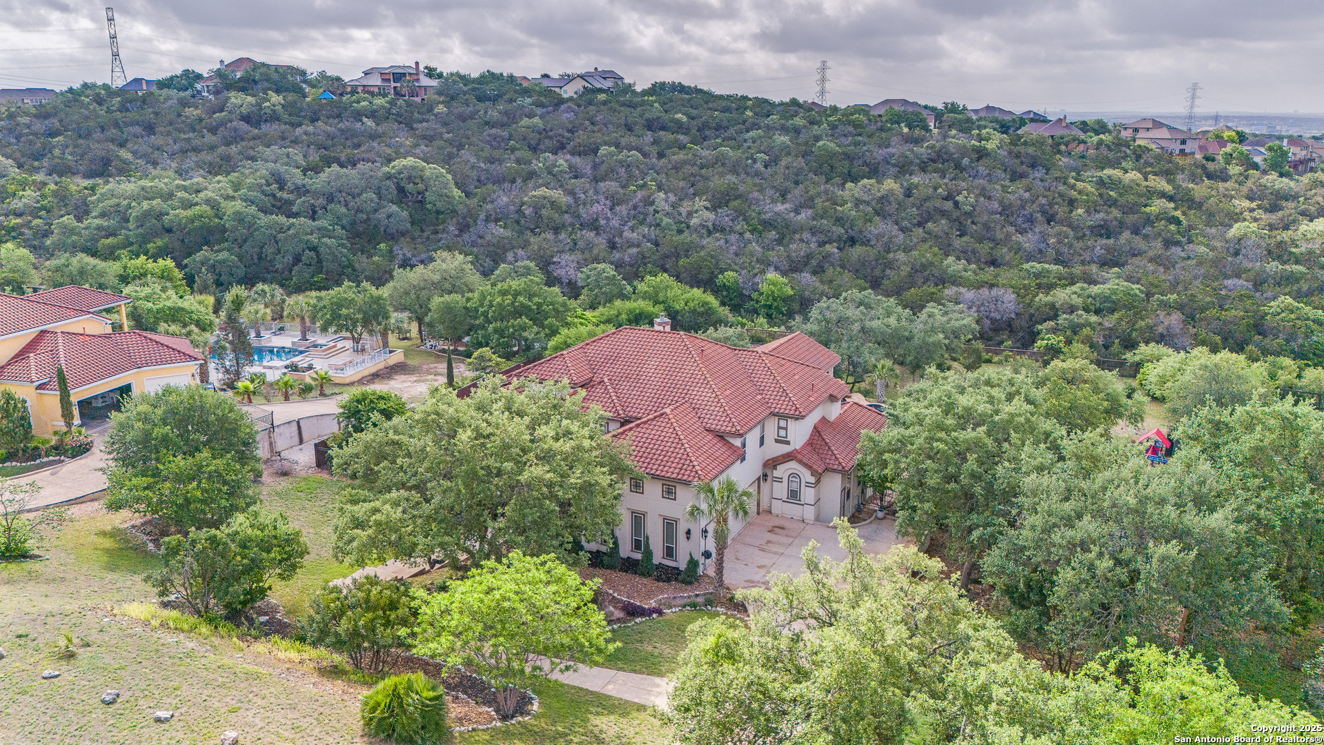 714 Ruidosa Downs Helotes, TX 78023 - Photo 39 of 42 an aerial view of a house with outdoor space and a lake view