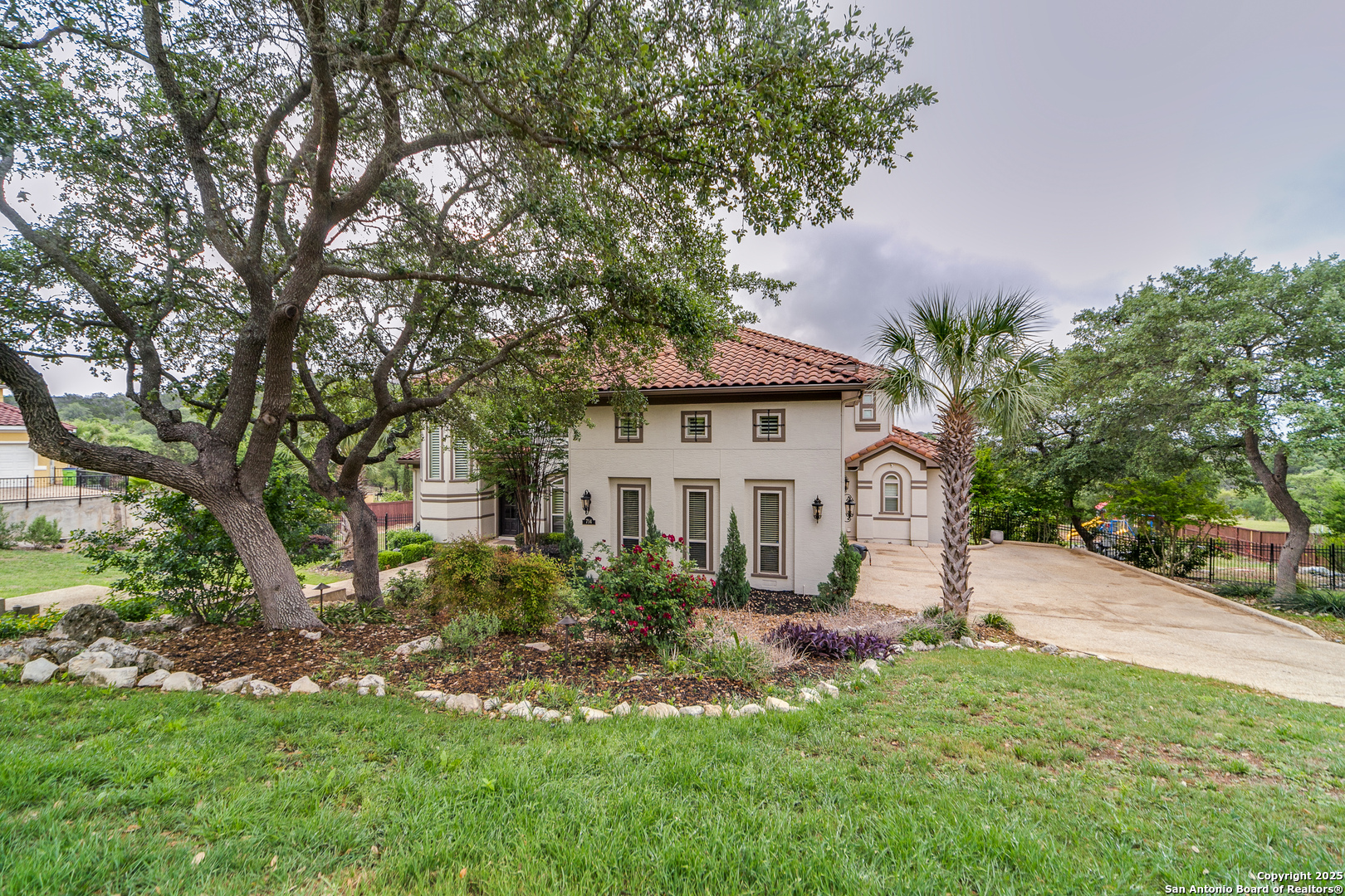 714 Ruidosa Downs Helotes, TX 78023 - Photo 4 of 42 a front view of a house with a garden