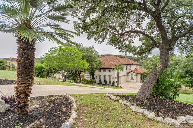 a view of a tree in front of a house