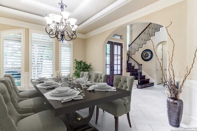 a view of a dining room with furniture wooden floor and chandelier