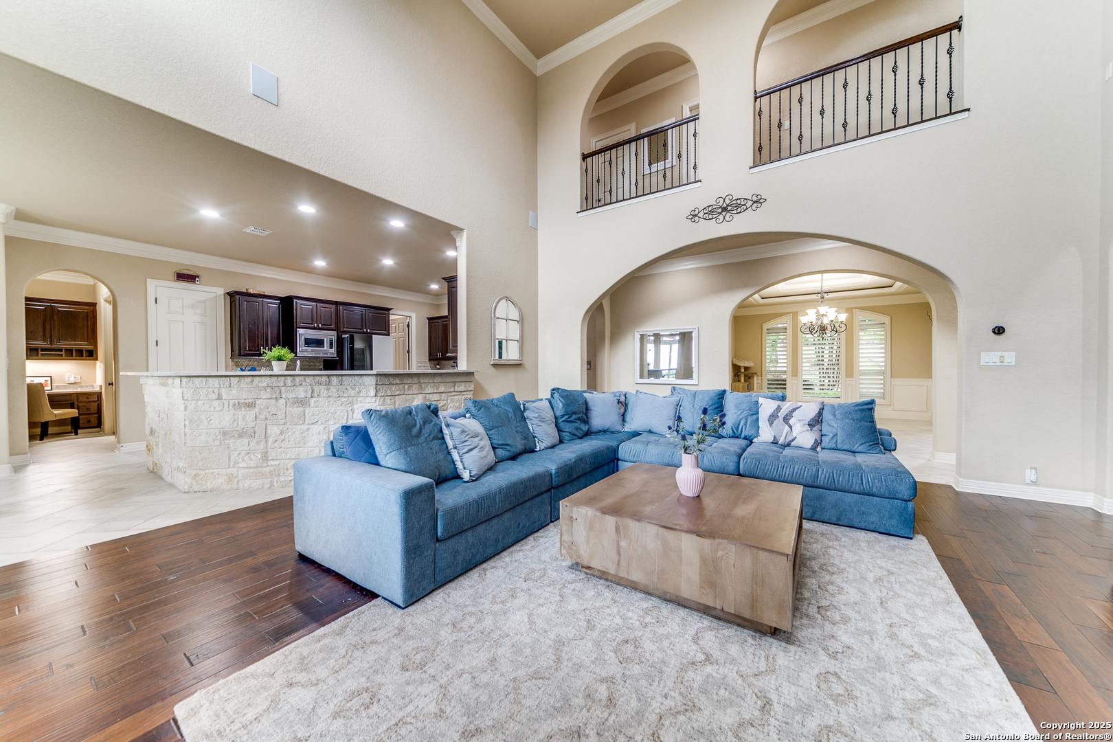 714 Ruidosa Downs Helotes, TX 78023 - Photo 9 of 42 a living room with couches and kitchen view with wooden floor