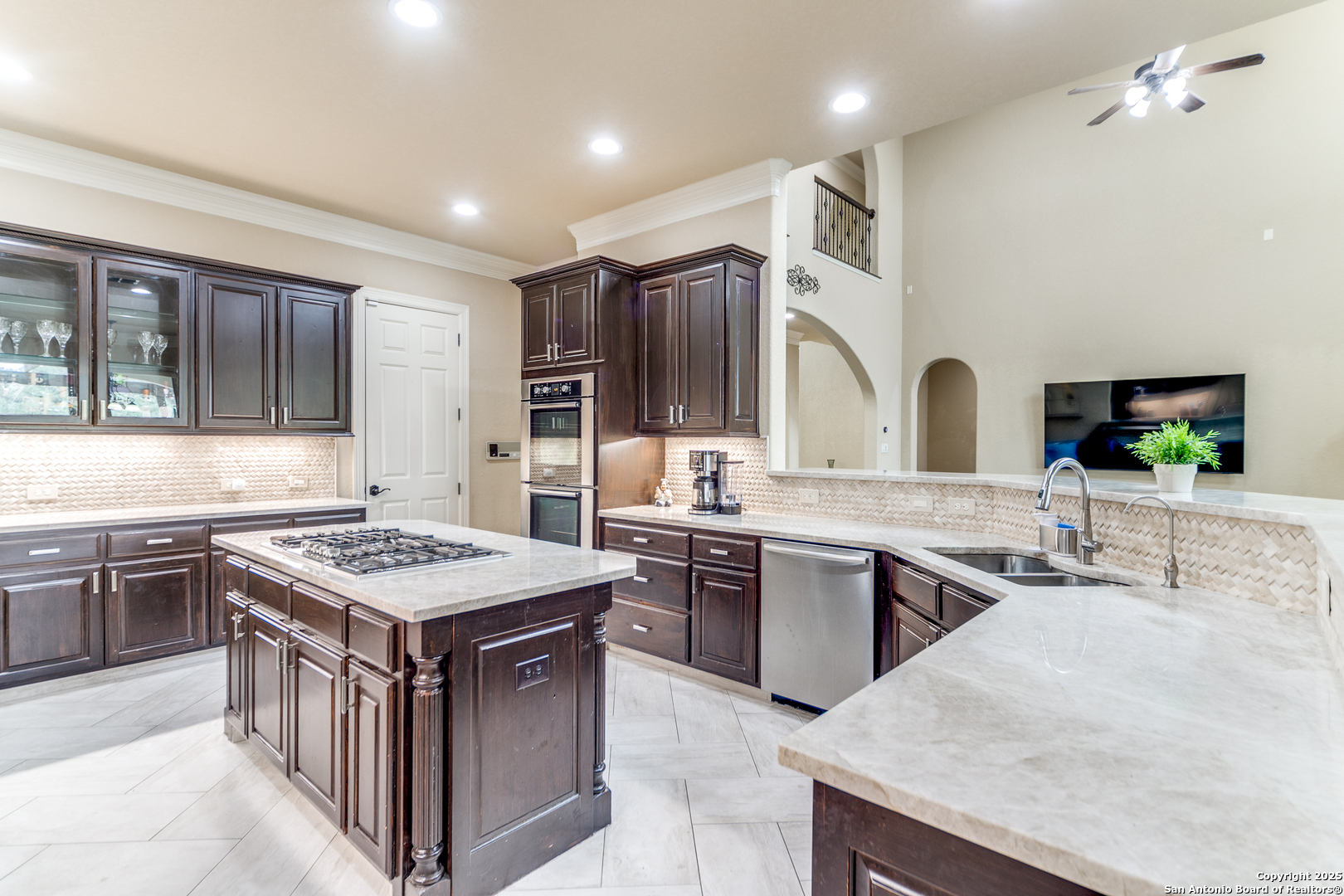 714 Ruidosa Downs Helotes, TX 78023 - Photo 10 of 42 a kitchen with lots of counter top space sink and stainless steel appliances
