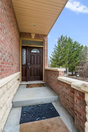 a view of a hallway with wooden floor and entryway