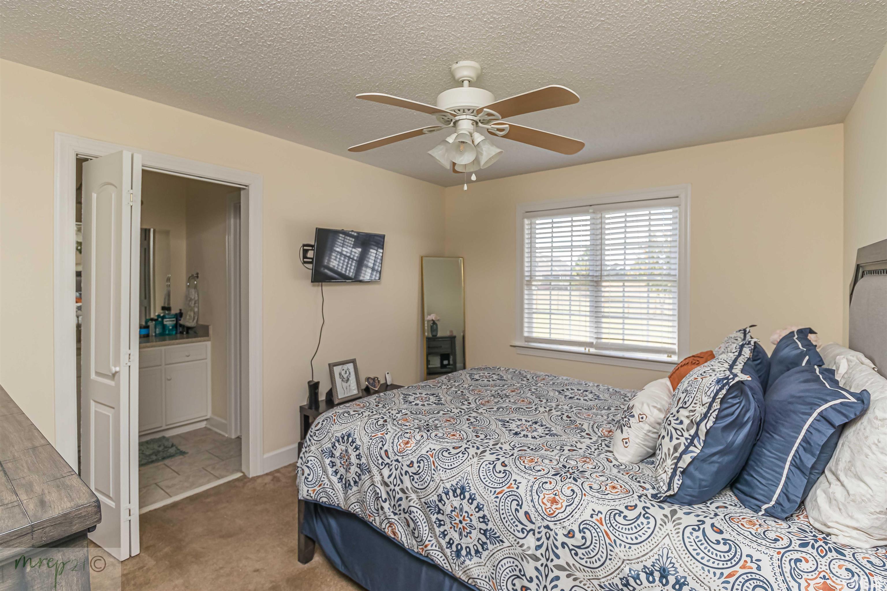 15838 Old Smithfield Road Sims, NC 27880 - Photo 13 of 27 a bedroom with a bed and a chandelier