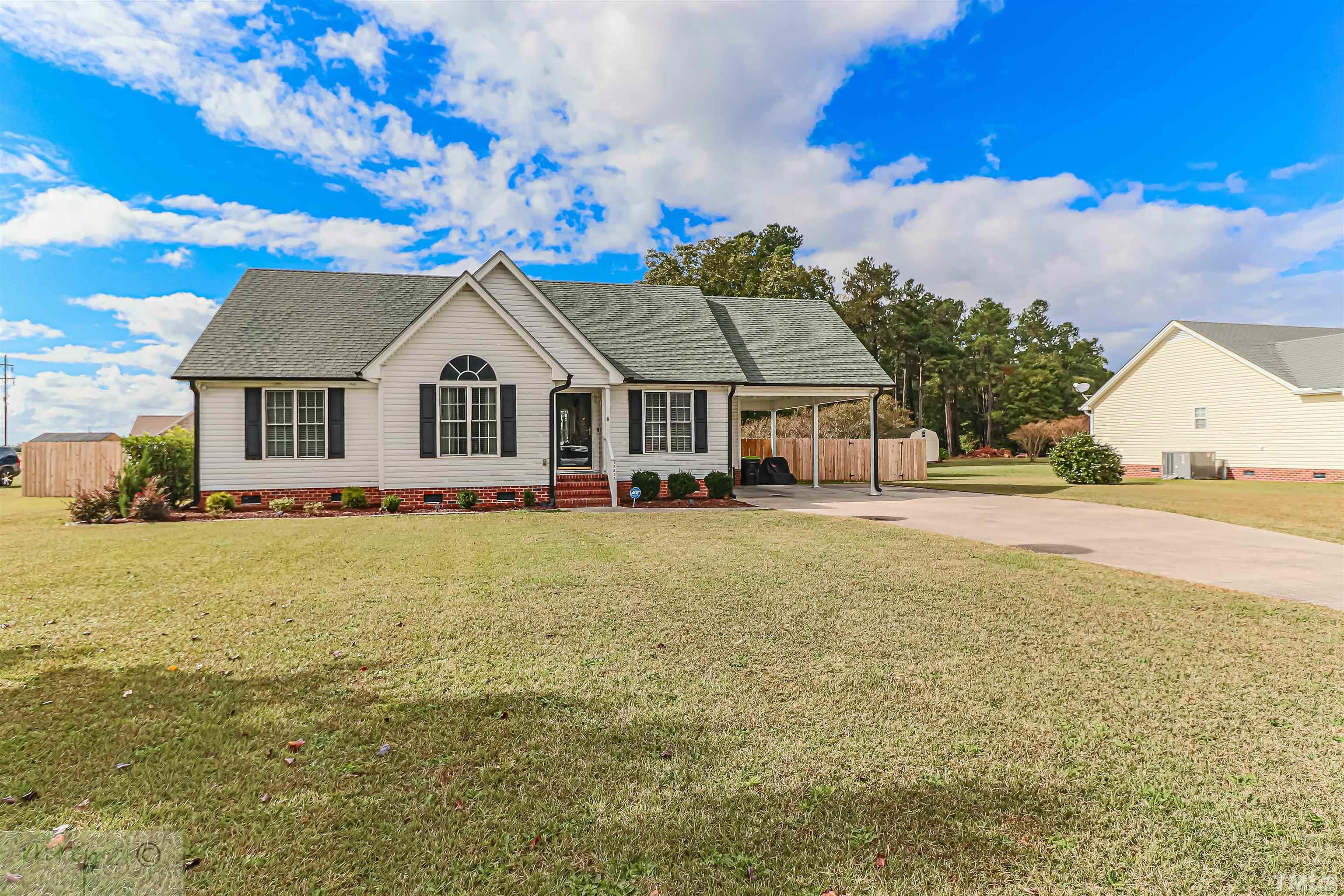 15838 Old Smithfield Road Sims, NC 27880 - Photo 3 of 27 a front view of a house with a garden and yard