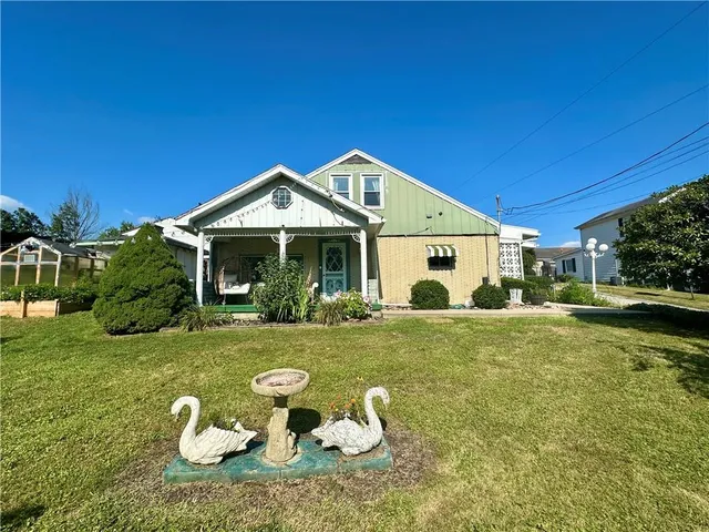 a front view of a house with a yard