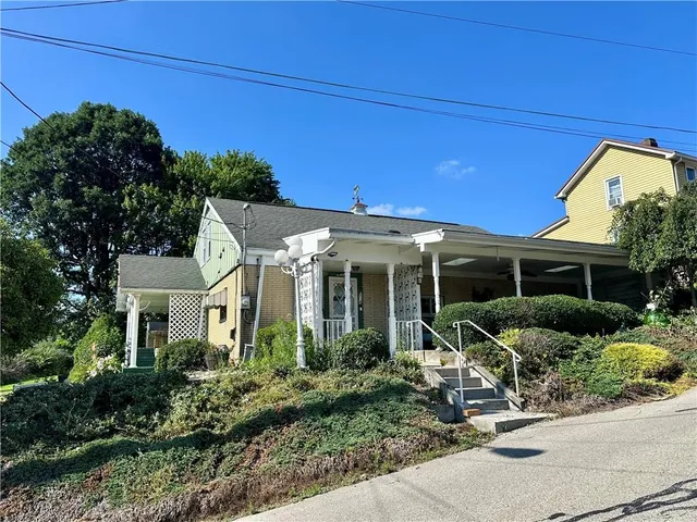 a front view of a house with garden