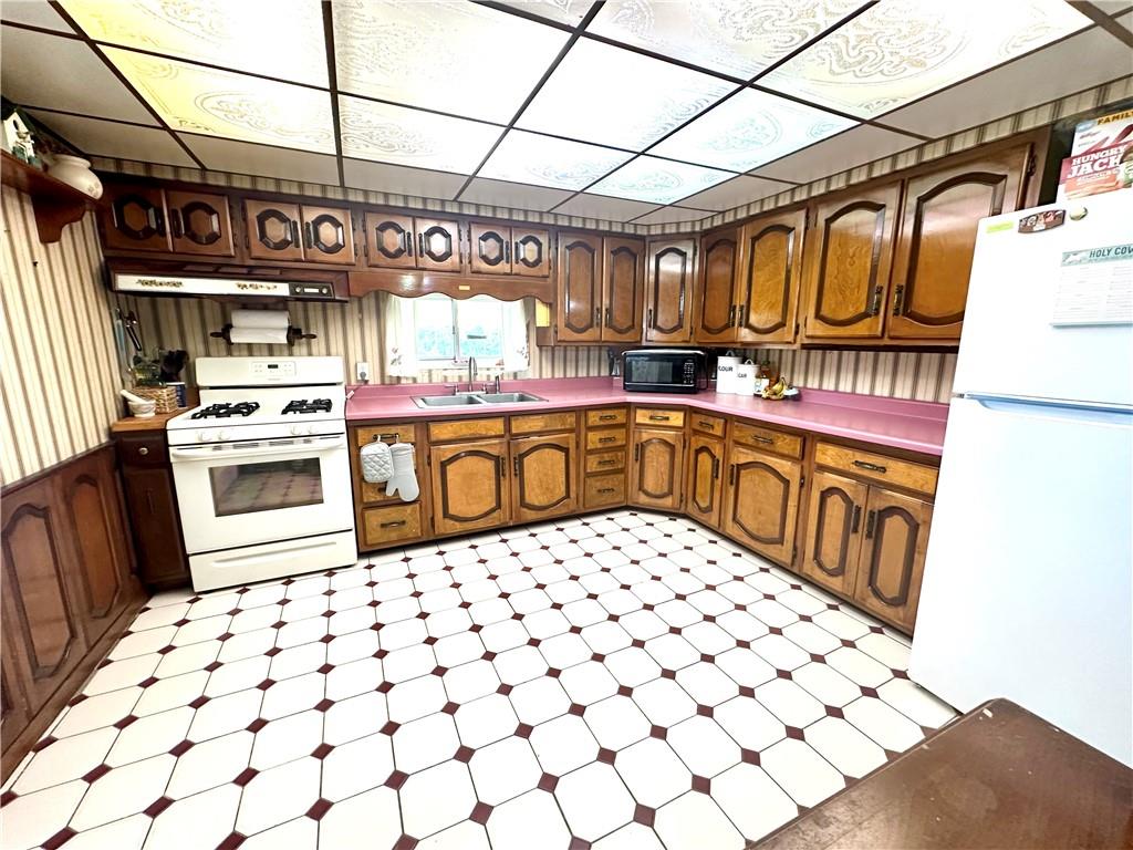 514 Southern Avenue Kittanning, PA 16201 - Photo 4 of 27 a kitchen with a stove a sink and a refrigerator