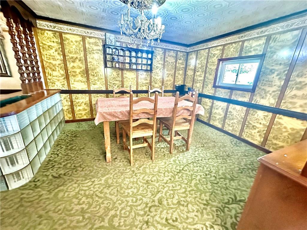 514 Southern Avenue Kittanning, PA 16201 - Photo 5 of 27 a dining room with furniture a chandelier and wooden floor