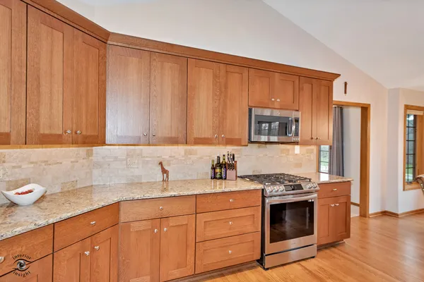 a kitchen with stainless steel appliances granite countertop a sink stove and cabinets