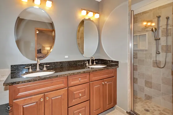 a bathroom with a double vanity sink and a mirror