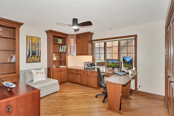 a living room with furniture a flat screen tv and a large window