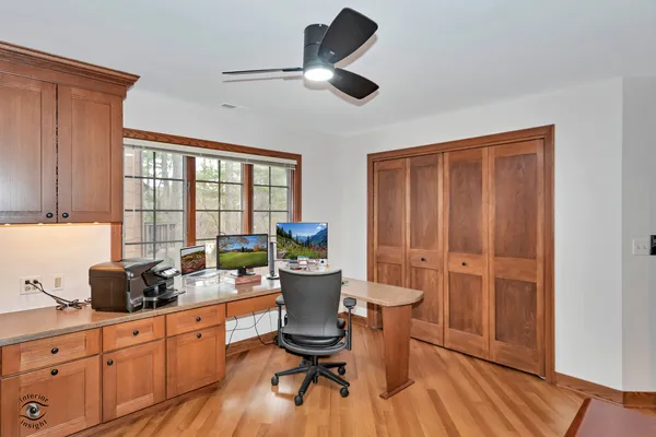 a kitchen with a wooden table and chairs