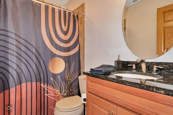 a bathroom with a sink a mirror a toilet and a mirror