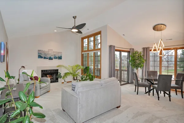 a living room with furniture large window and flat screen tv