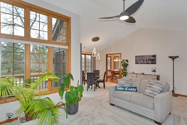 a living room with patio furniture and a potted plant