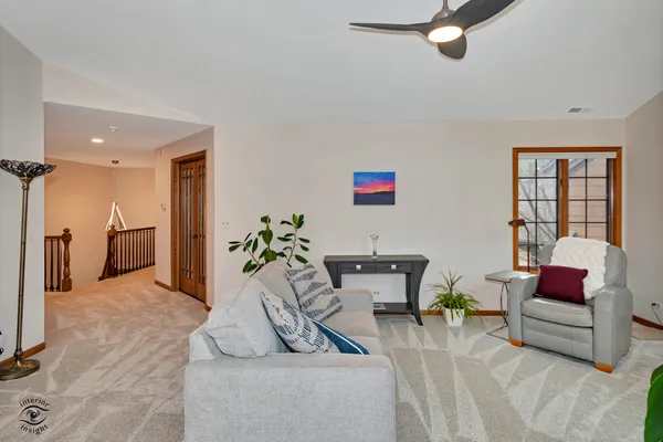 a living room with furniture and a potted plant
