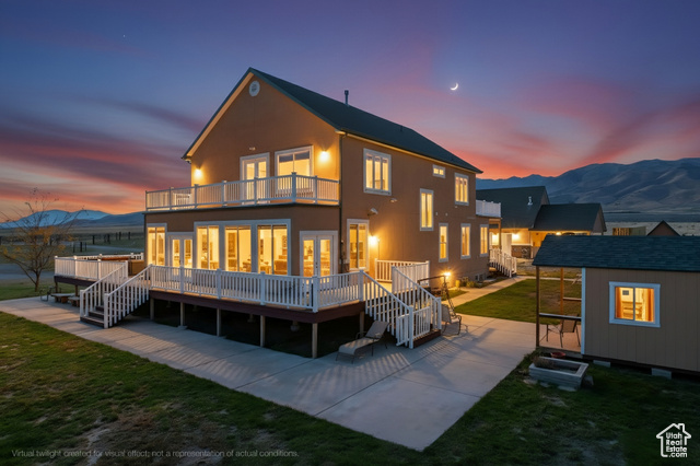 4768 East Hickman Canyon Road Stockton, UT 84071 - Photo 61 of 85 Rear view of house featuring a mountain view, a yard, an outbuilding.