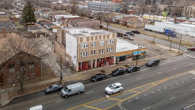 an aerial view of a building with parked cars
