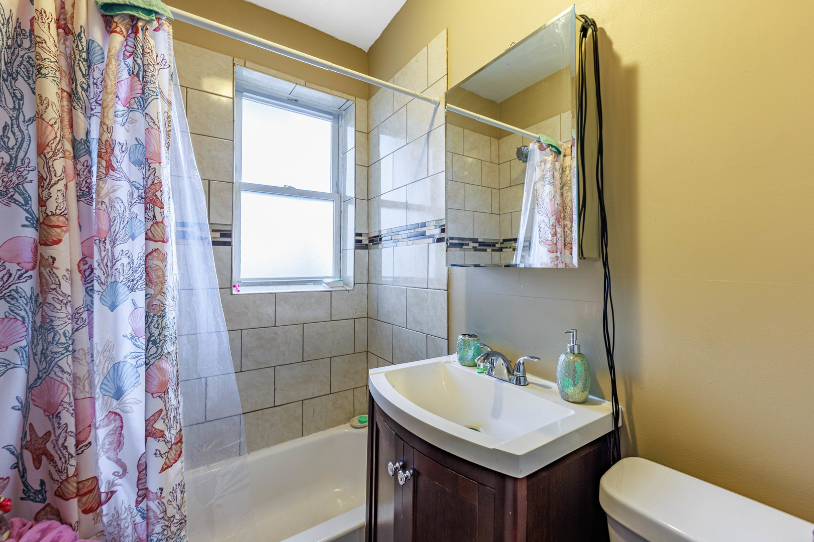 1513 West 87th Street Chicago, IL 60620 - Photo 16 of 28 a bathroom with a sink toilet vanity and shower