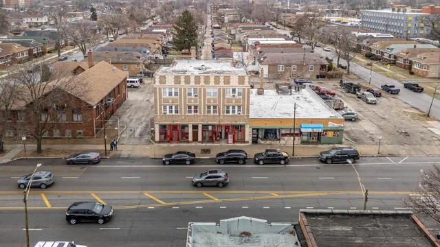 an aerial view of a building with parked cars